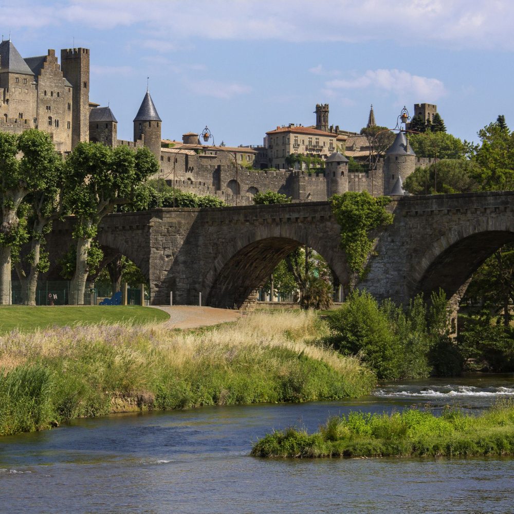 The medieval fortress and walled city of Carcassonne in south west France. Founded by the Visigoths in the fith century, it was restored in 1853 and is now a UNESCO World Heritage Site. Viewed over the Pont Vieux crossing the Aude River.